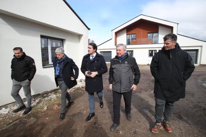 El consejero Quiñones con el alcalde de Carracedelo, Raúl Valcarce, y el delegado de la Junta, Eduardo Diego, en la visita a los chalés pareados de Posada del Bierzo. ANA F. BARREDO