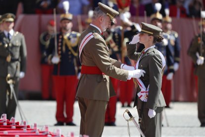 Felipe VI impone la banda a la princesa de Asturias, su hija Leonor, durante la ceremonia en la que le entregó su despacho de alférez tras un año en Zaragoza, este miércoles. EFE/ Javier Cebollada