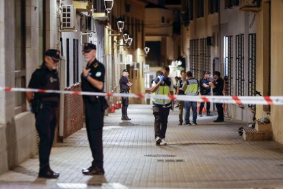 Agentes de policía cercan la calle donde se ha producido un tiroteo en el que varias personas han resultado heridas este sábado por la tarde en Málaga capital.