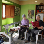 Dos vecinos consultan sendos ejemplares en la biblioteca de Valdorria.