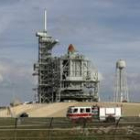 Un camión de bomberos pasa junto a la plataforma donde ya está la lanzadera espacial «Discovery»