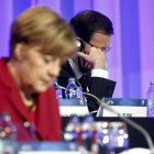 Merkel, junto a Mariano Rajoy, durante la reunión del Partido Popular Europeo.