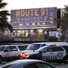 Vehículos policiales bajo una señal que indica la localización del festival country. PAUL BUCK
