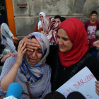 La hermana de Moussa y Driss Oukabir (izquierda) llora desconsolada en un acto contra el terrorismo, en Ripoll.