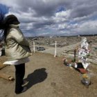 Una mujer se detiene frente a un cenotafio construido por supervivientes del tsunami.
