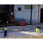 Dos operarios realizan obras en los andenes ya visibles de la estación de Feve. MARCIANO