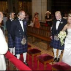 El novio con el traje escocés recibe a la novia acompañada de su padrino