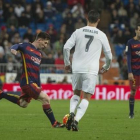 Messi chuta ante Cristiano Ronaldo.