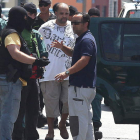 El detenido, con camiseta blanca, es conducido a un vehículo de la Guardia Civil.