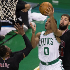 El jugador de Celtics Avery Bradley (c) se dirige a canasta ante la marca de Dwyane Wade (i) y Nikola Mirotic (d), de los Bulls.