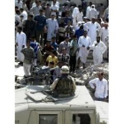 Cientos de iraquíes observan a un soldado tras la explosión en Faluja