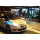 Un vehículo de la Policía Local delante del escaparate de la tienda K2 en cuyo escaparate los ladrones estrellaron un vehículo para acceder al interior.