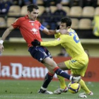 Rossi (d) y el defensa de Osasuna Miguel Flaño luchan por un balón