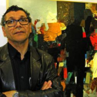 El artista iraquí Hanoos ante una de las obras de la exposición.