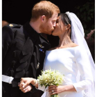 La pareja recién casada exhibe su amor con el clásico beso. NEIL HALL / POOL