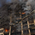 Los bomberos tratan de extinguir las llamas de un edificio del centro de Kiev bombardeado por Rusia. ROMAN PILIPEY