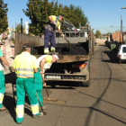 Los operarios municipales, esparciendo aglomerado en la localidad de Trobajo del Camino. DL