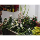 Una florista de León elabora un tradicional ramo de flores para recordar a los difuntos.