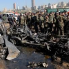 Grupos de policías libaneses observan el estado del coche empleado para el atentado terrorista
