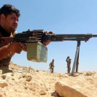 Un combatiente kurdo dispara su arma en el frente de Bashiqa, a 13 kilómetros al nordeste de Mosul, el 12 de agosto.