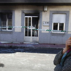 La hermana de la víctima, que vive en la primera planta, muestra su preocupación y pena por el siniestro ante la vivienda destrozada.
