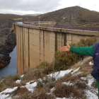 Un agricultor mostraba hace unos días cómo la presa deja pasar el agua que han aportado este año la lluvia y la nieve. DL