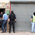 Varios guardias civiles, a las puertas de una de las viviendas registradas ayer en Valladolid.