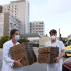 Dos sanitarios recogen pizzas en un hospital. KIKO  HUESCA