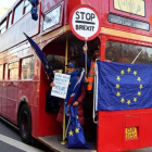 Un activista anti-brexit muestra una bandera de la UE en un autobús de Londres.