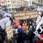 Pancartas en las que se lee «Marionetas de los banqueros, no tenéis donde esconderos».