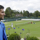 Djokovic observa las pistas de Wimbledon tras el entrenamiento del domingo.