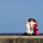 Una pareja se abraza en el malecón de La Habana.