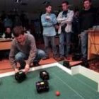 Unos estudiantes de ingeniería preparan sus robots para que jueguen un «partido de fútbol»