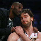 Kobe Bryant consuela a Pau Gasol en el banquillo de los Lakers.