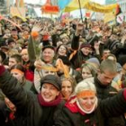 Seguidores de Viktor Yushchenko portando banderas de victoria ayer en Kiev