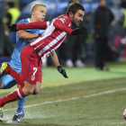 Adrián, autor del gol del Atlético de Madrid, intenta escaparse del marcaje de Smolnikov.