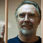 El australiano Colin Russell, el último miembro de Greenpeace que permanecía arrestado, saluda tras los barrotes de su celda en la cárcel de San Peterburgo.