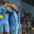 Los jugadores del City celebran un gol ante un triste Messi.