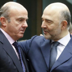 El ministro espanol de Economia, Luis de Guindos, conversa con el comisario europeo de Asuntos Economicos, Pierre Moscovici, en enero del 2016.