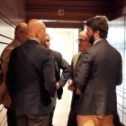 Gallardo conversa con el consejero Veganzones y procuradores de Vox en los pasillos de las Cortes. LETICIA PÉREZ
