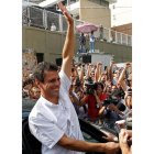 Capriles y Chávez saludan a sus seguidores momentos antes de depositar su voto.