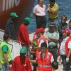 Miembros de la Cuz Roja reciben a los inmigrantes rescatados en alta mar