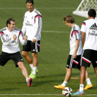 Módric, a la derecha junto a Varane, regresó ayer a los entrenamientos tras su lesión.
