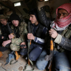 Rebel fighters ride a military vehicle, as they advance towards the northern Syrian town of al-Bab, Syria January 15, 2017.