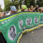 Varias mujeres y hombres lloran la muerte del expresidente sudafricano Nelson Mandela frente a su última residencia en Johannesburgo, ayer, viernes .