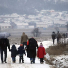 Refugiados sirios, iraquíes y afganos, en un camino nevado.