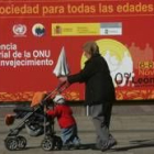 An elderly woman goes for a walk with her grandson around San Marcos during the conference