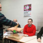 Un trabajador deposita su voto en la urna, en presencia de los representantes del comité de empresa