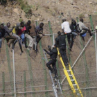 Inmigrantes en la valla fronteriza de Melilla, este miércoles.