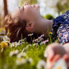 Una mujer, tendida en la hierba en primavera.